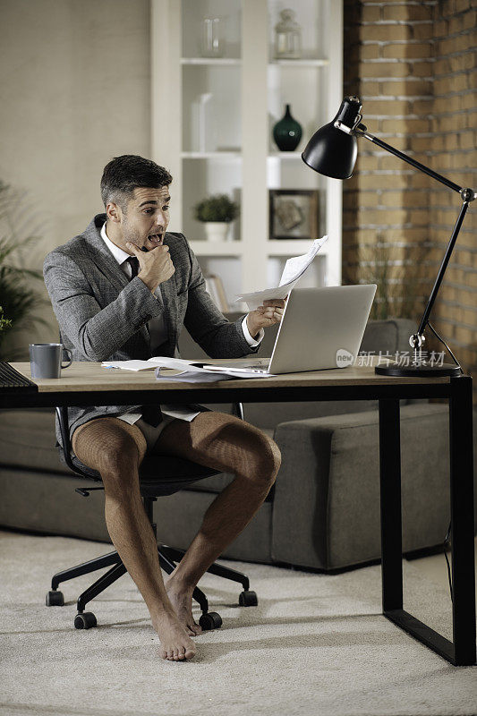 Businessman having a video call with a laptop at home stock photo